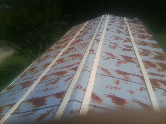 Rusted metal roof panels with new wood purlins before replacement — Storm Damage Roof Repair in Estero by Roofing Brothers